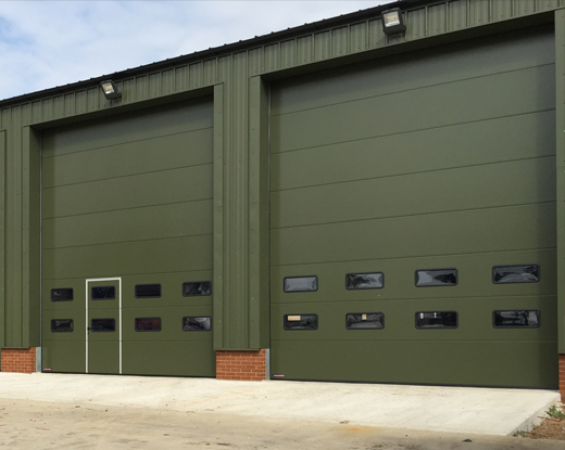 gas-pipeline sectional doors industial with wicket door in green